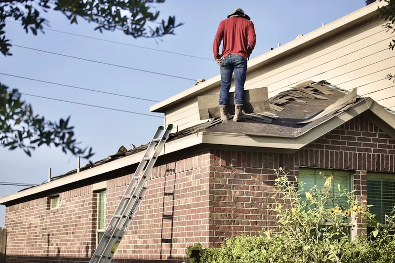 Professional roofer working on a residential roof in Saxapahaw